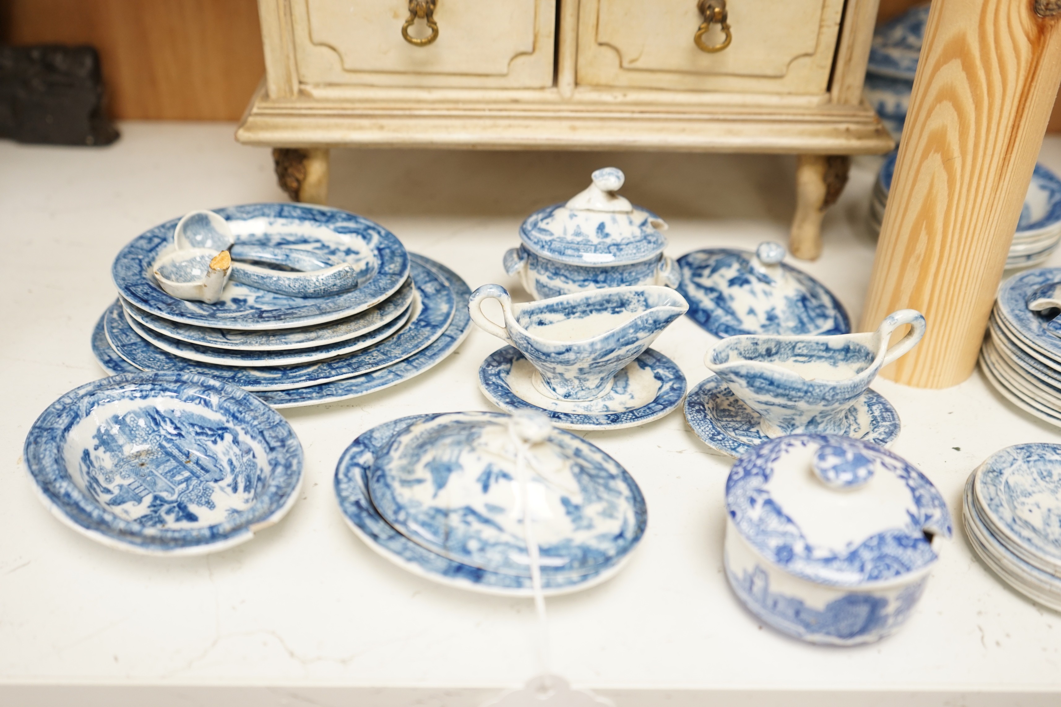 A Victorian toy-size blue and white dinner service and a painted wooden miniature chest, chest 27cms high